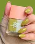 A square bottle of green nail polish.