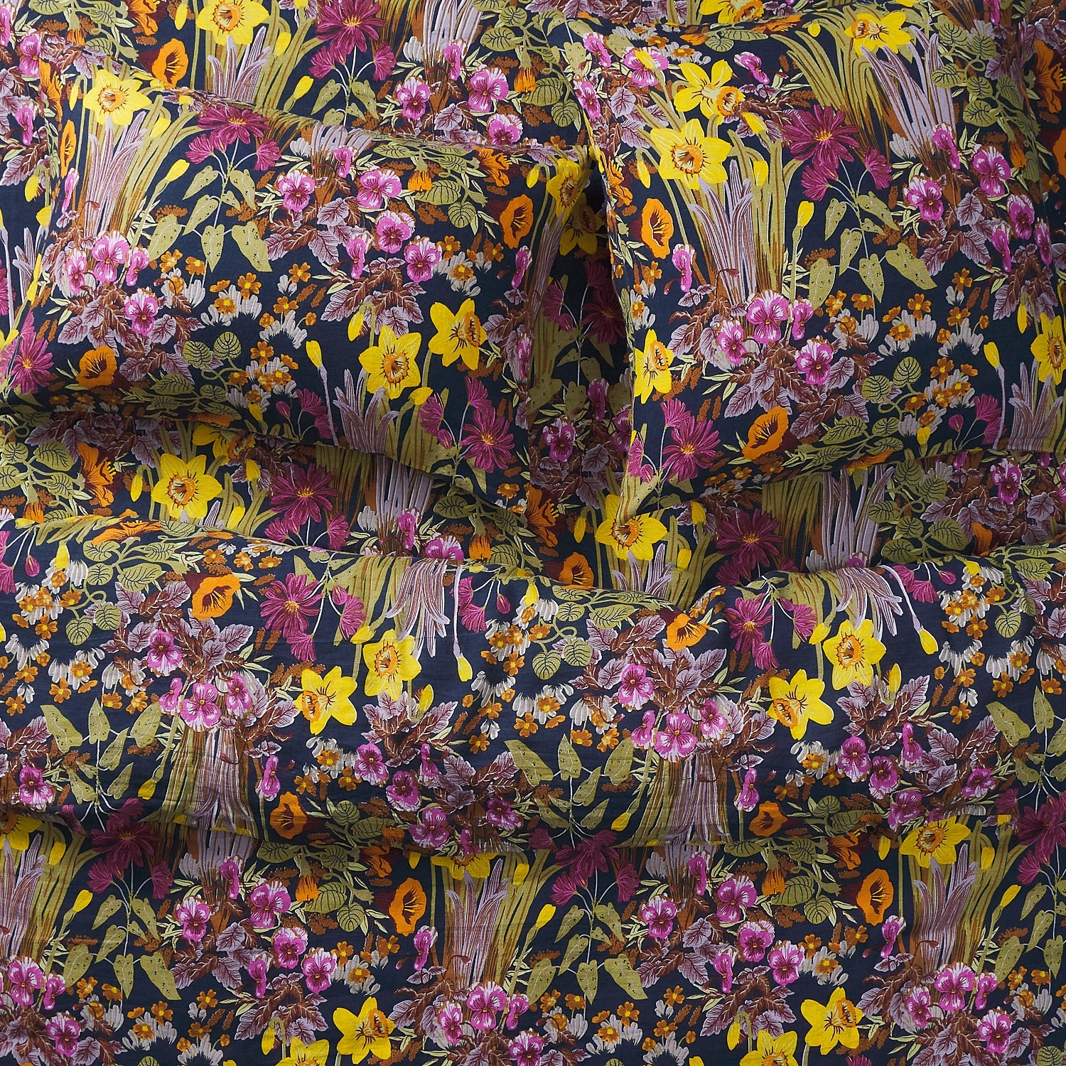 Beautiful floral print bedding showing pillows and a comforter from above.