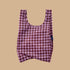 A pink and burgundy pattern nylon tote bag.
