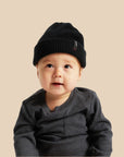 A black beanie on a baby. 