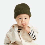 On a white background is a baby wearing the military olive colored knit beanie. 