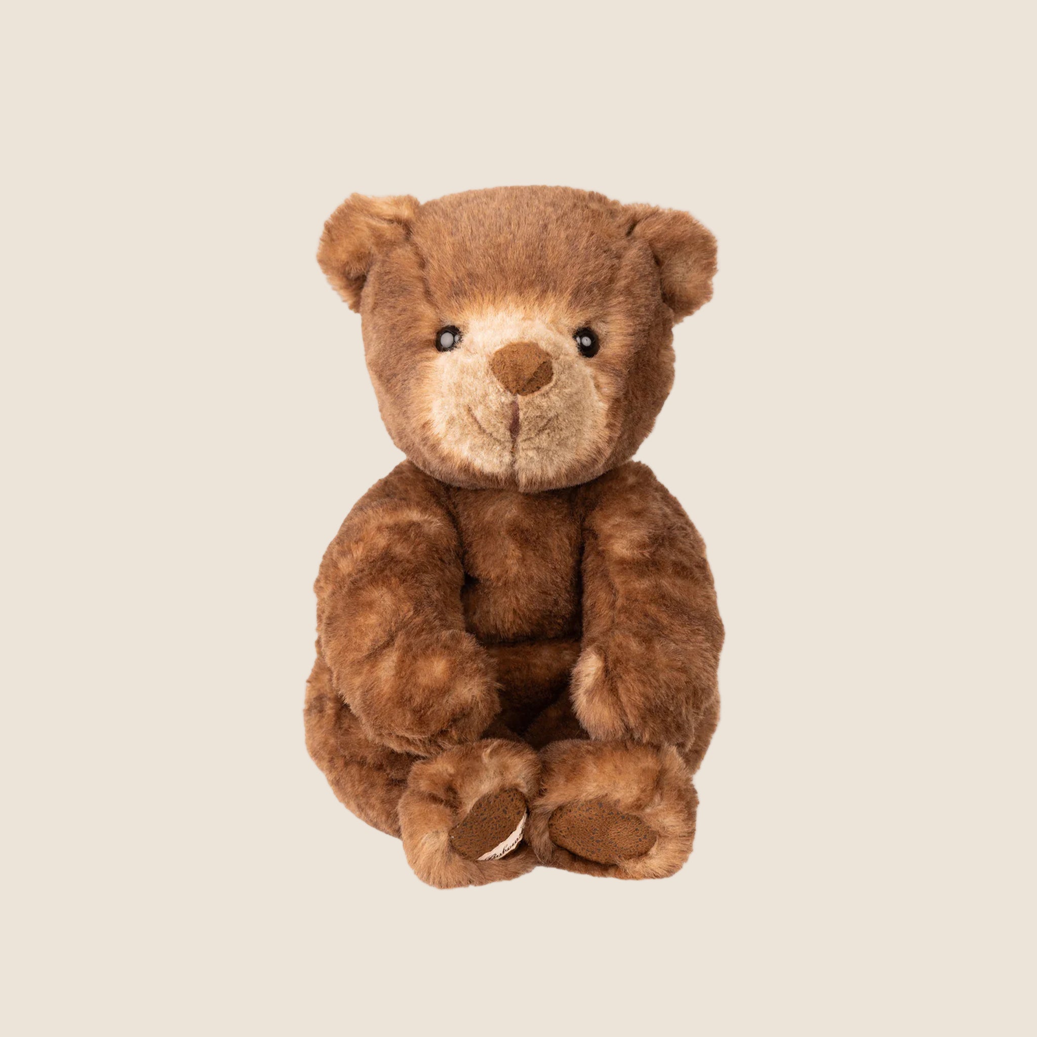 A brown and tan baby bear stuffed animal toy. 