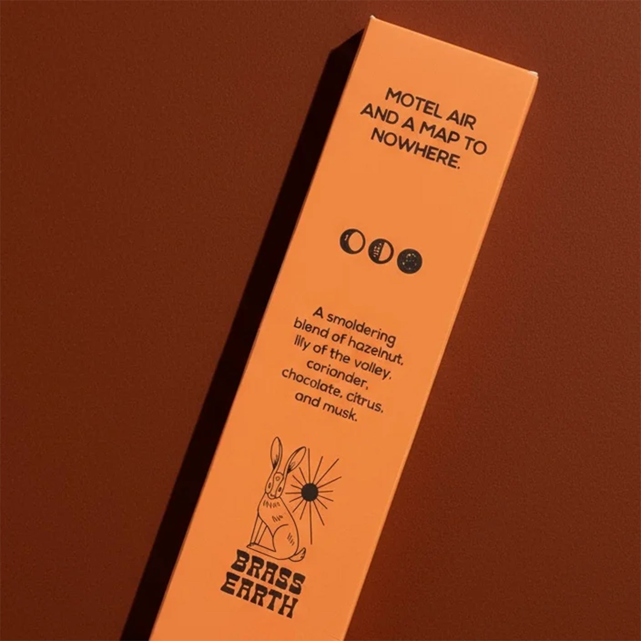 Orange product packaging with text and branding on a brown background
