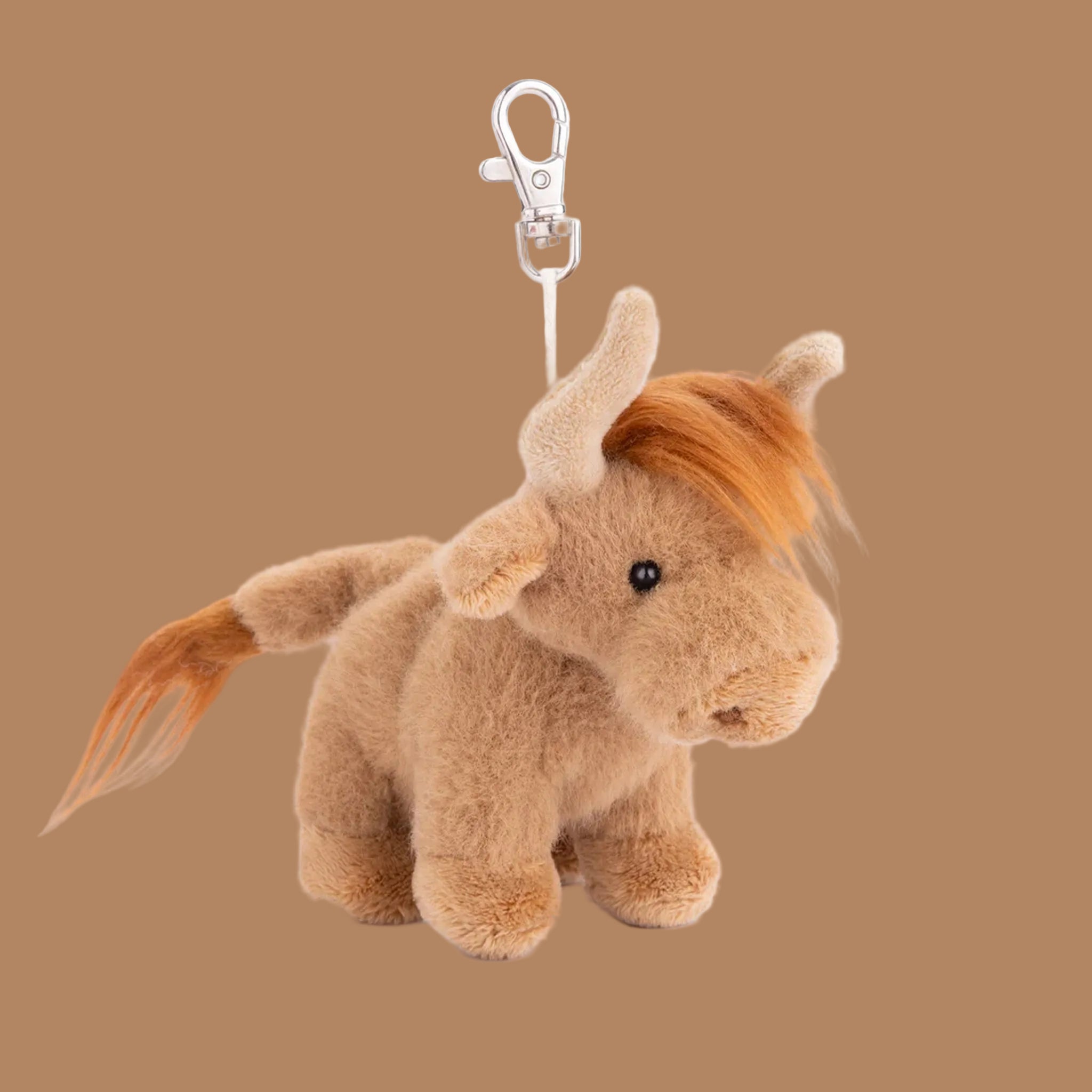 A mini highland cow stuffed toy keychain bag charm. 