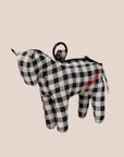 A black and white checkered horse shaped bag charm. 