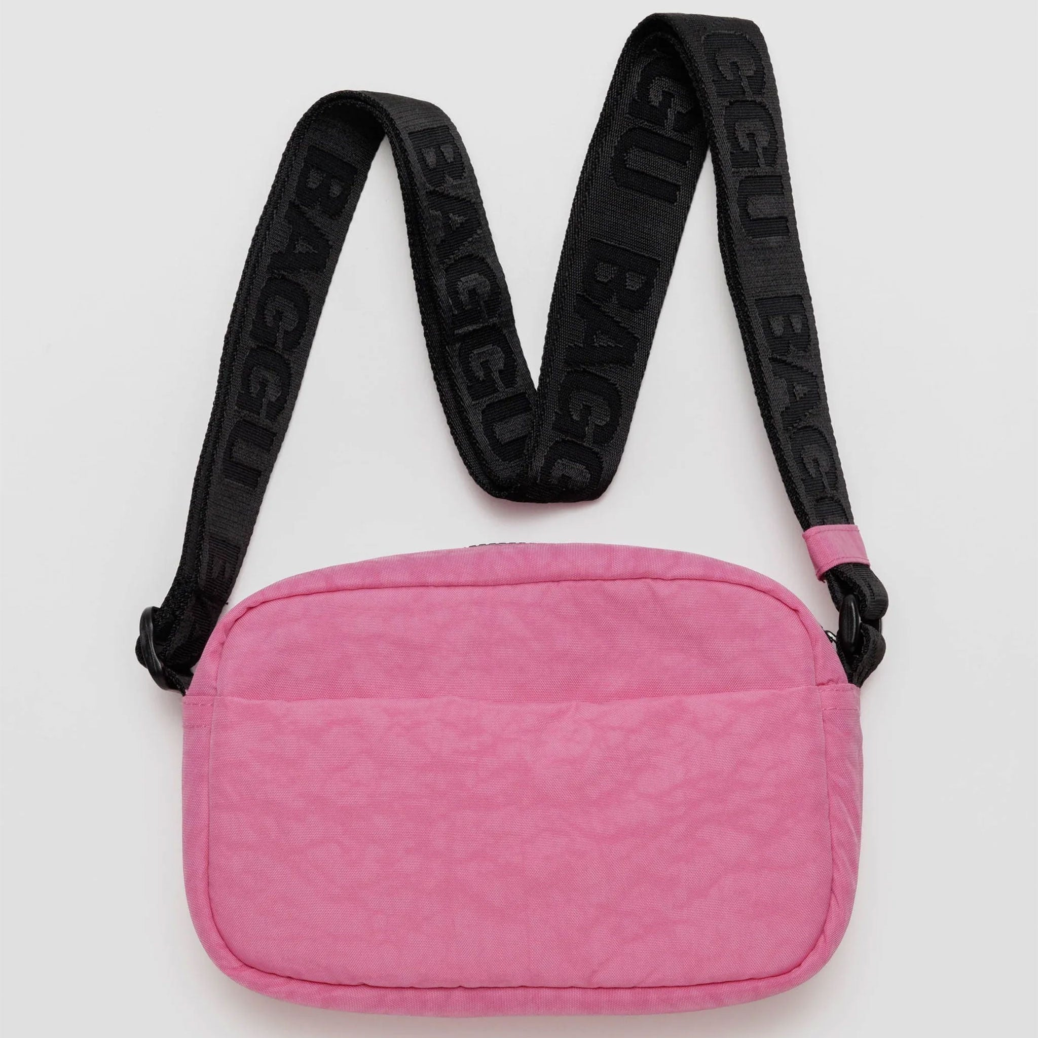 a bright pink rectangle shaped bag with black strap