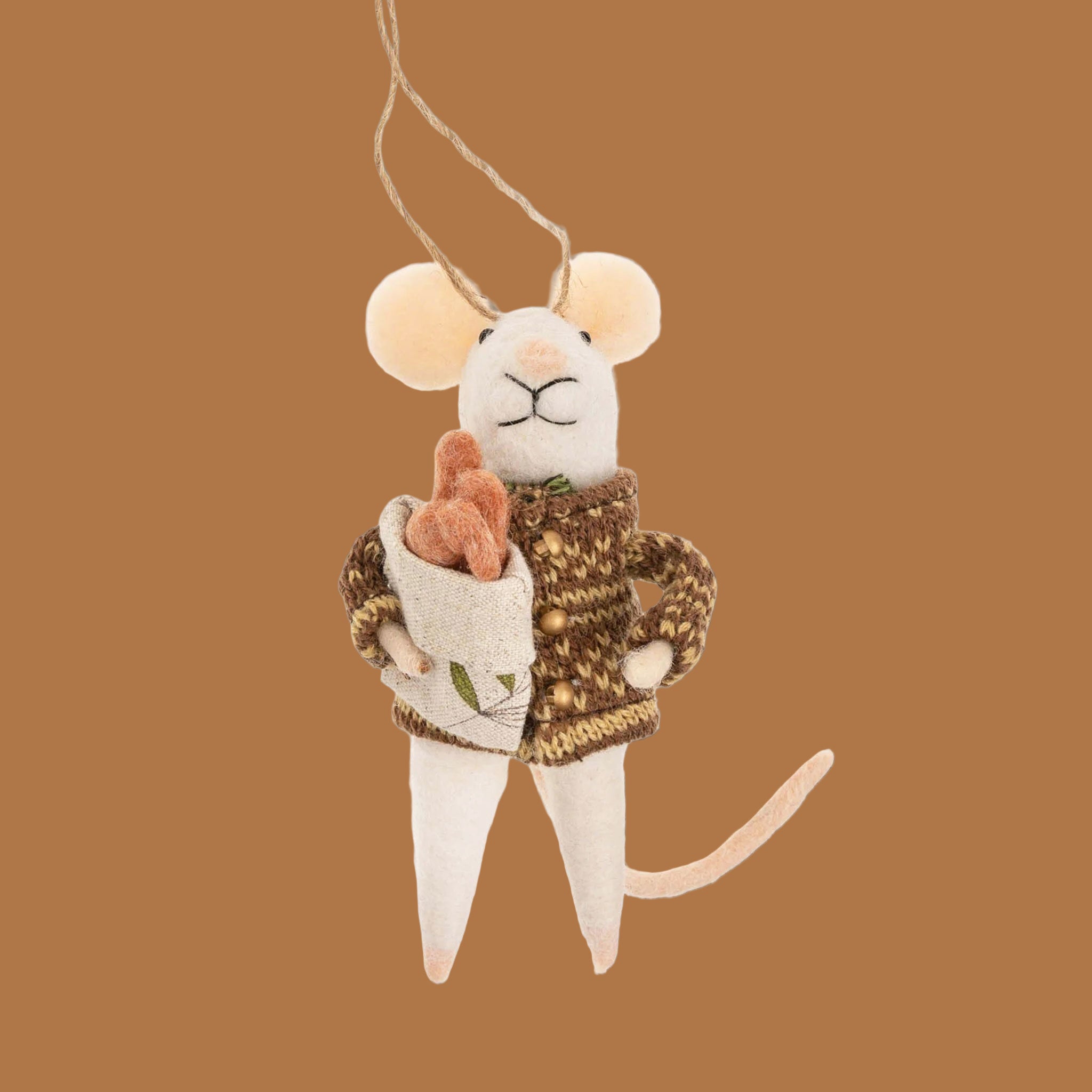 A white mouse shaped ornament wearing a cardigan and holding a pack of baguettes. 