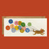 Greeting card with a dog carrying a bunch of balloons in its mouth. Each balloon has a gold foil letter spelling out "Happy Birthday".