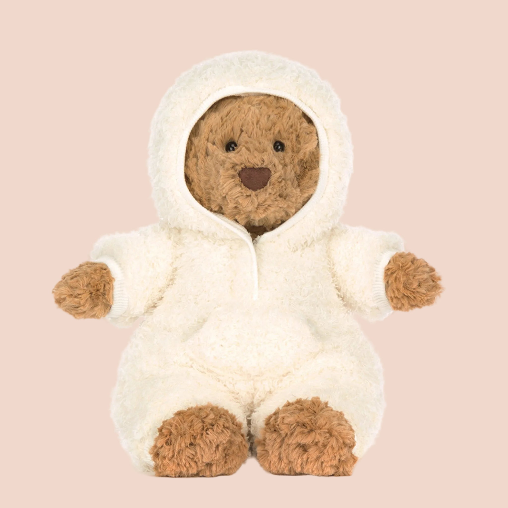A bear shaped stuffed animal toy with a single white fluffy outfit on. 