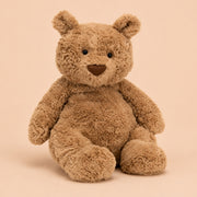 Brown teddy bear on a beige background
