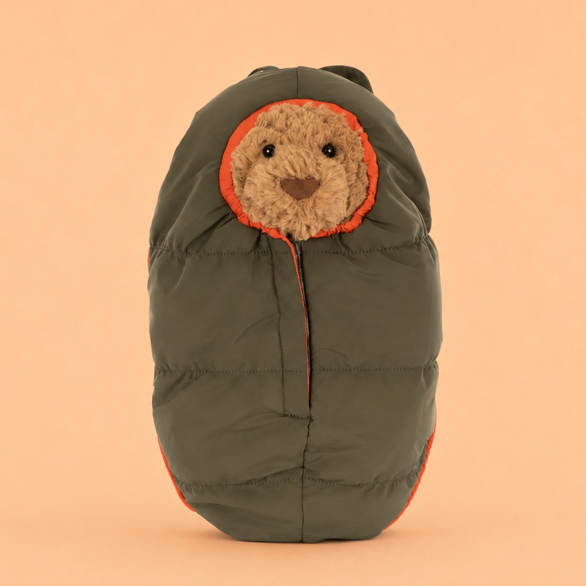 Teddy bear wearing a sleeping bag. 
