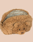 A tan furry pouch with a bear face in the center. 