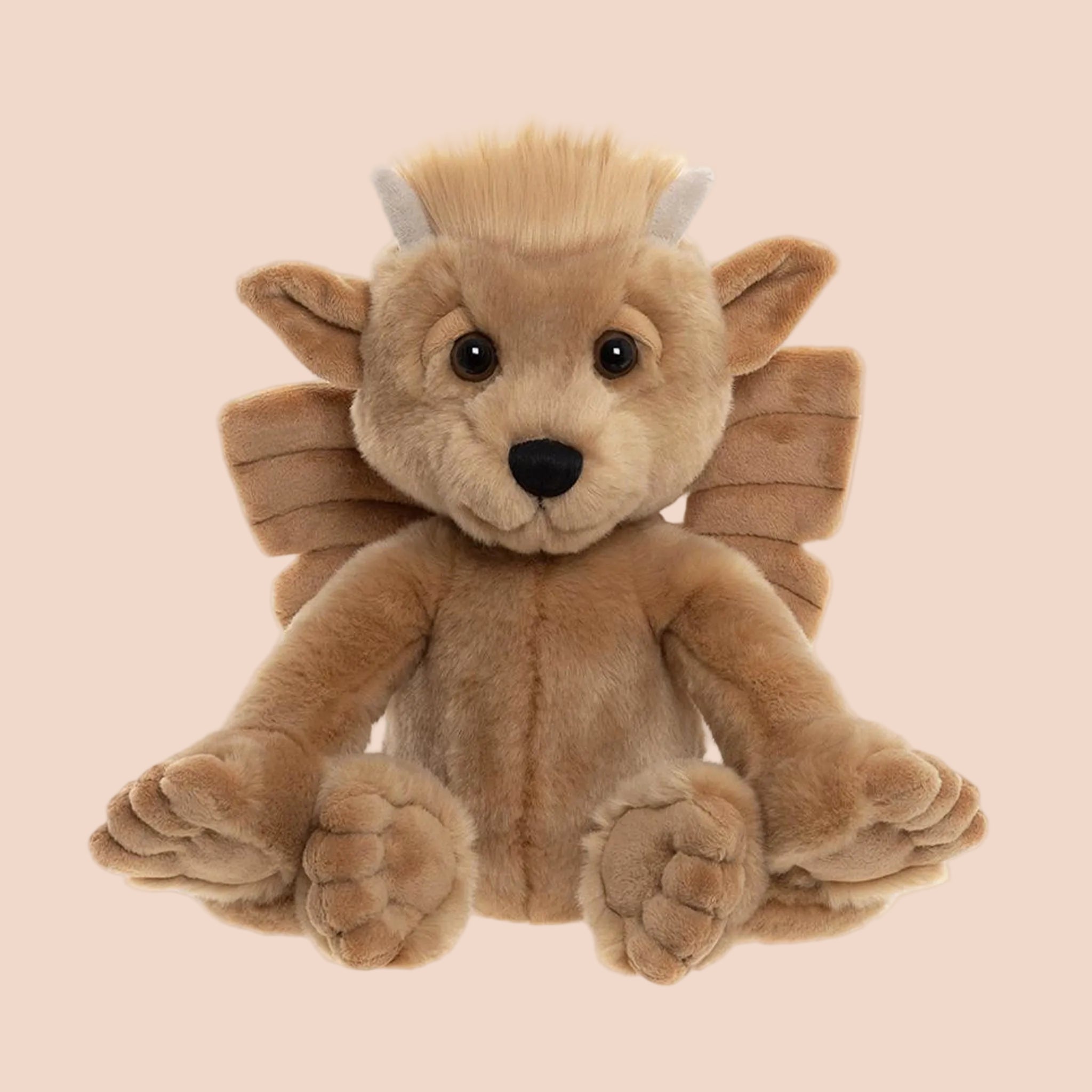 a tan mythical stuffed animal toy. 