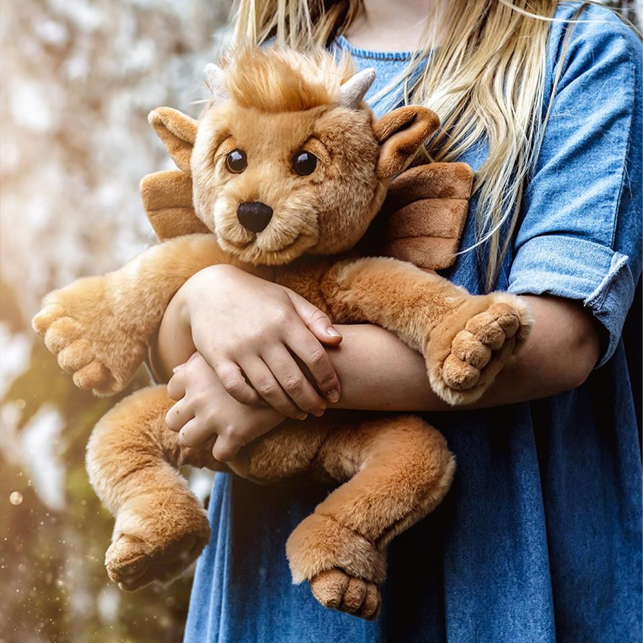 a tan mythical stuffed animal toy. 