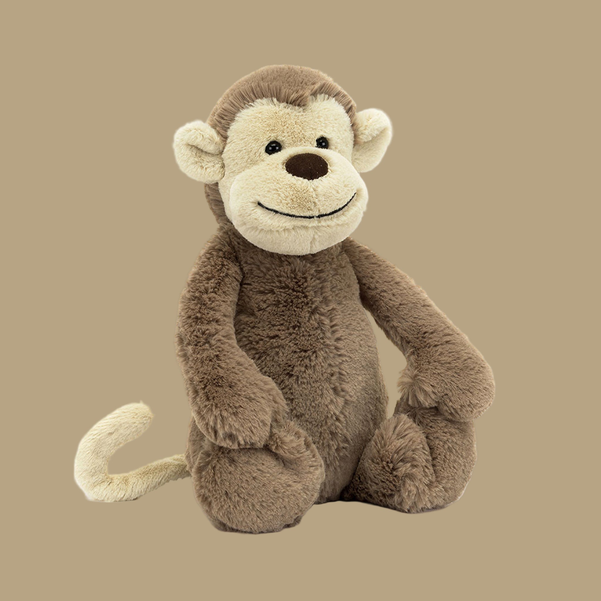 A brown monkey shaped stuffed animal. 