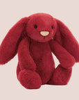A red bunny stuffed animal toy. 