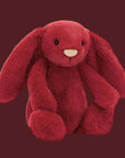 A red bunny stuffed animal toy. 