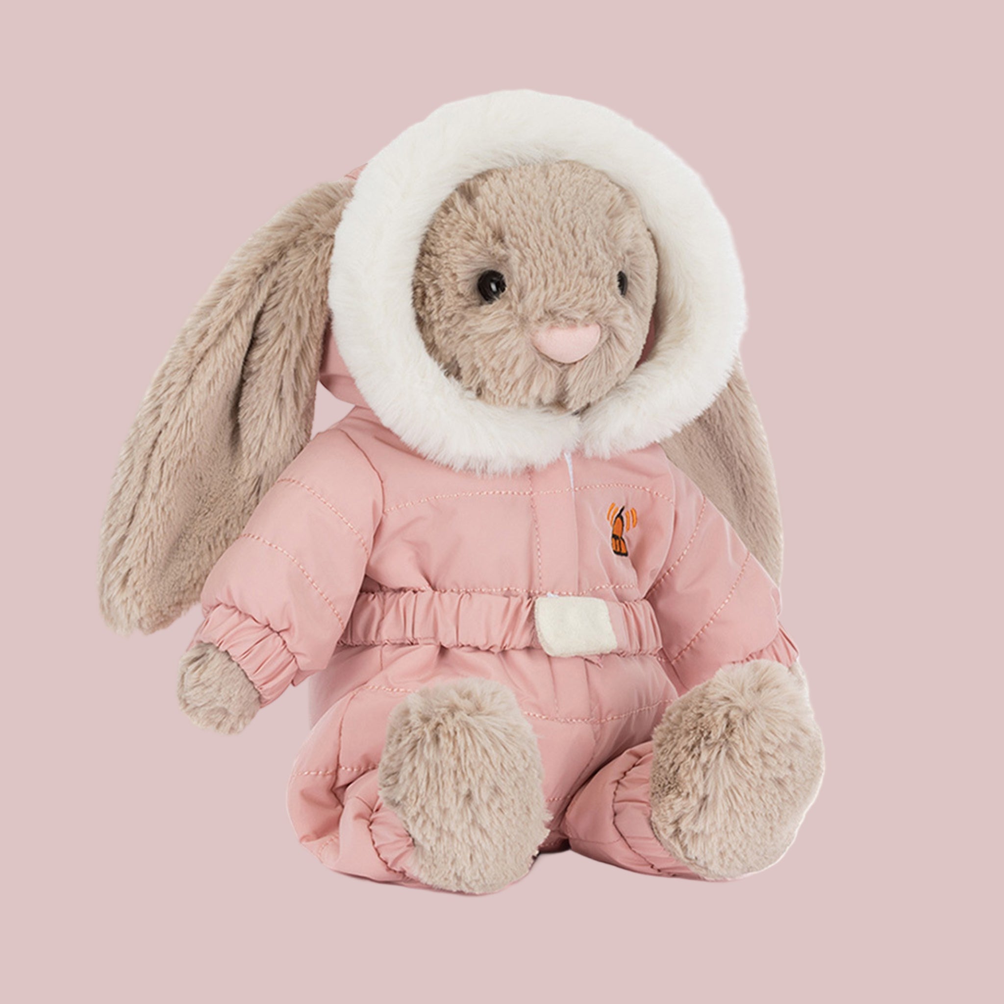 A bunny shaped stuffed toy wearing a pink snowsuit. 