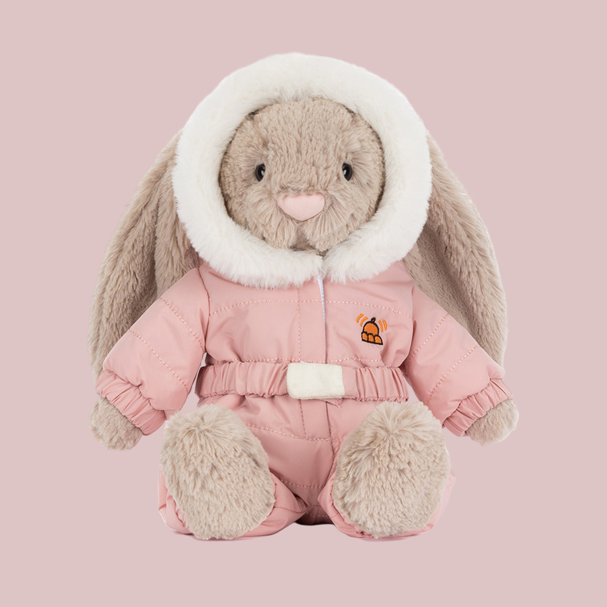 A bunny shaped stuffed toy wearing a pink snowsuit. 