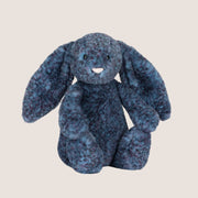 A dark blue speckled bunny shaped stuffed toy. 