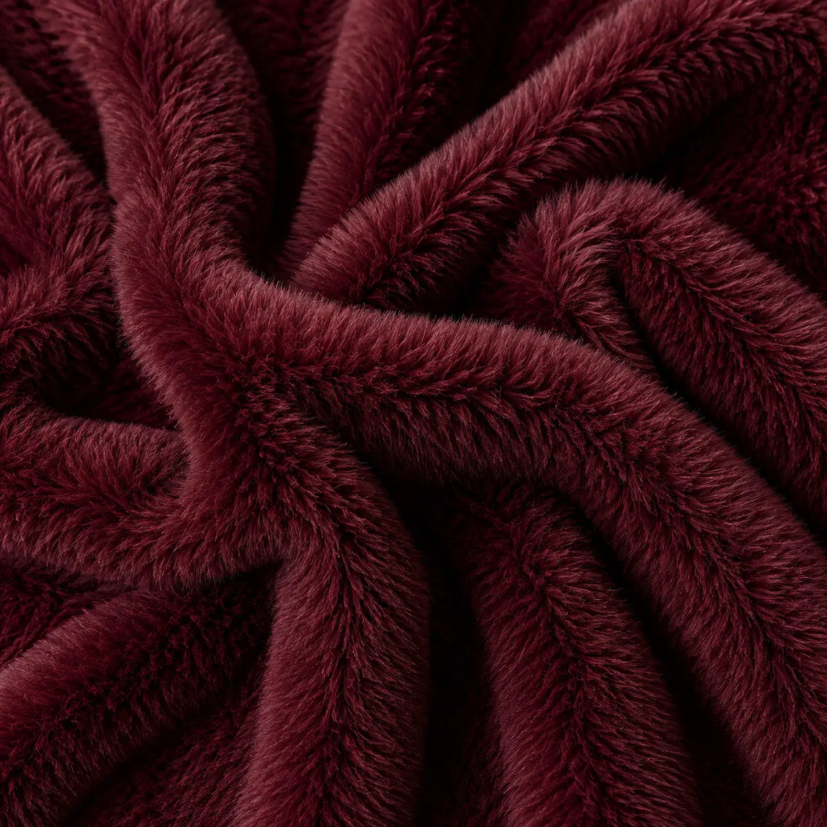 A ruby colored fur blanket with a tag that reads "bestie"