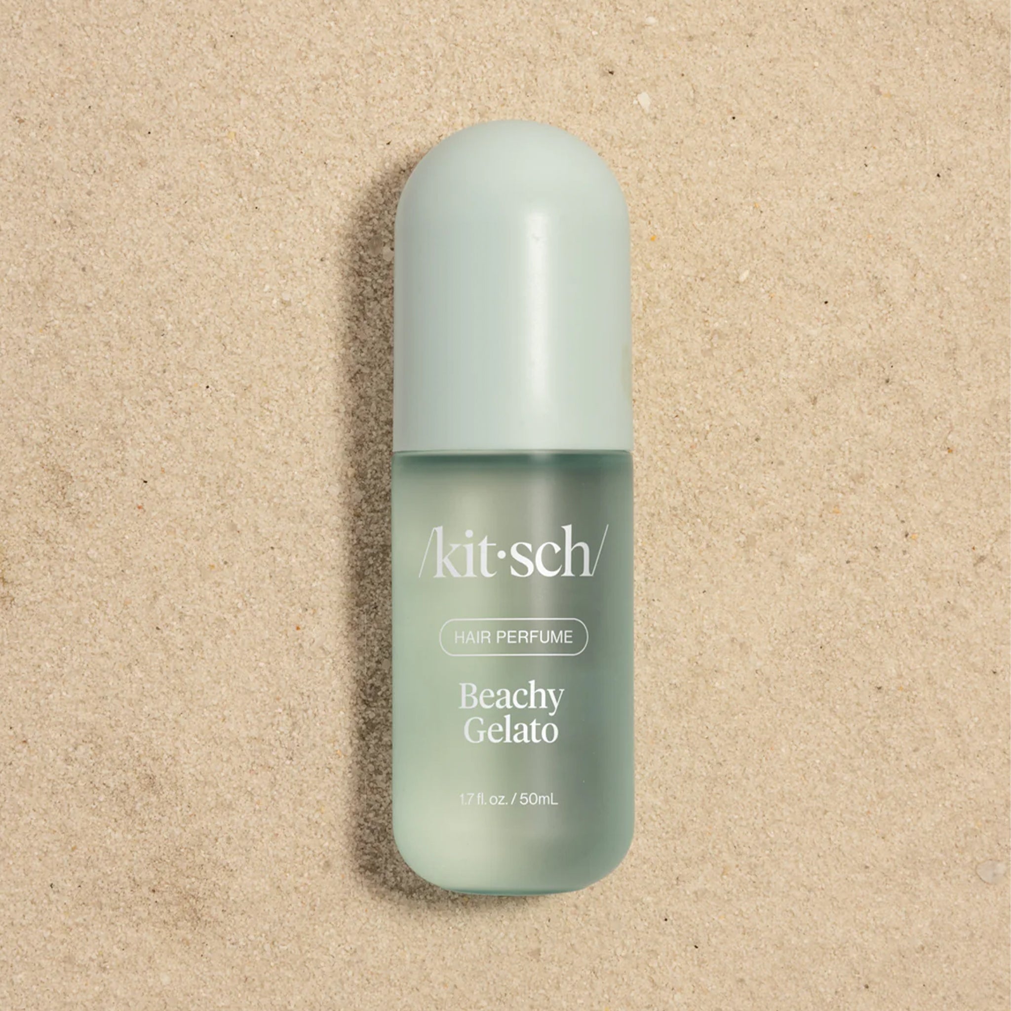 A blue hair spray bottle that reads, "kitsch Beachy Gelato". 