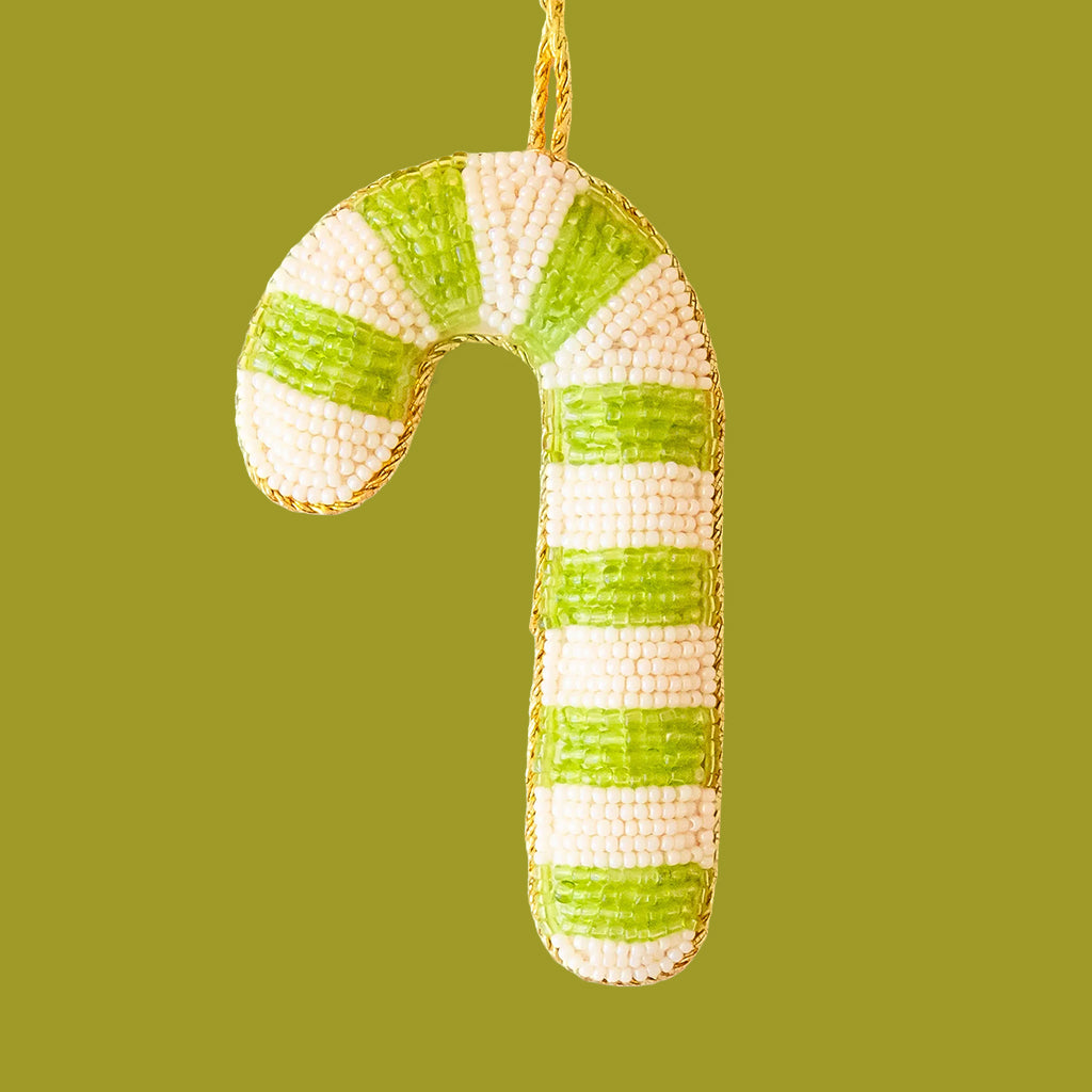 Decorative candy cane ornament with green and white stripes on a solid background
