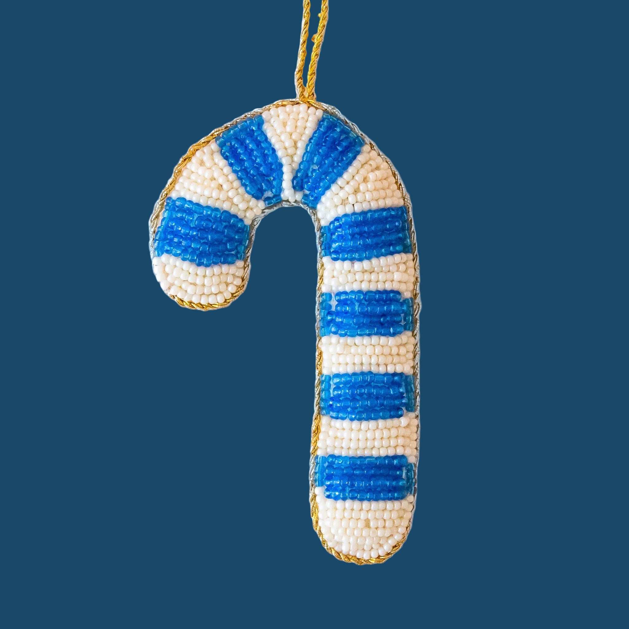 A blue and white beaded candy cane ornament. 