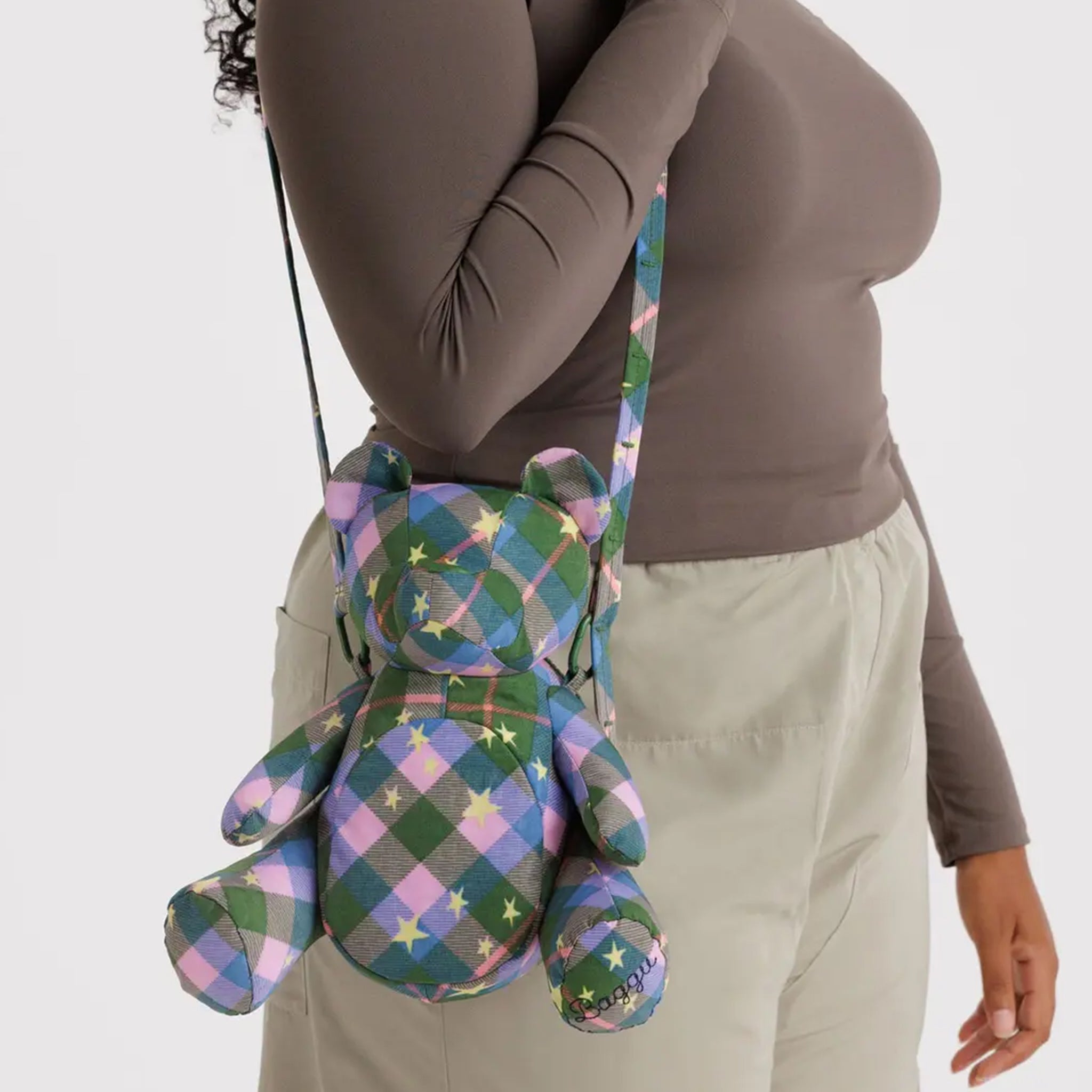 A plaid green, pink and blue bear shaped cross body bag with yellow star details. 