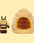 A bee shaped stuffed toy along with a honeybee hive shaped toy.