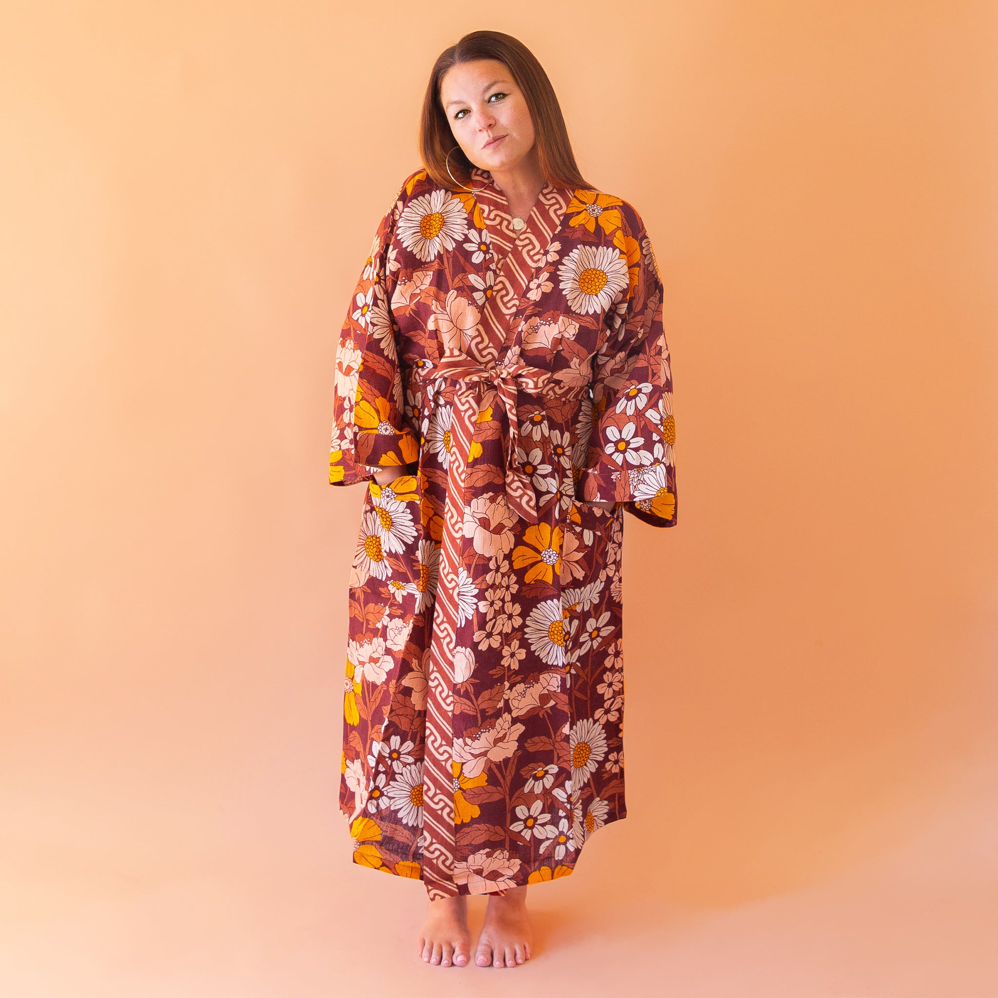 A rust, yellow and cream 70's inspired floral print linen robe.