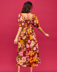 A mutli colored floral print maxi dress with puff sleeves and pockets.