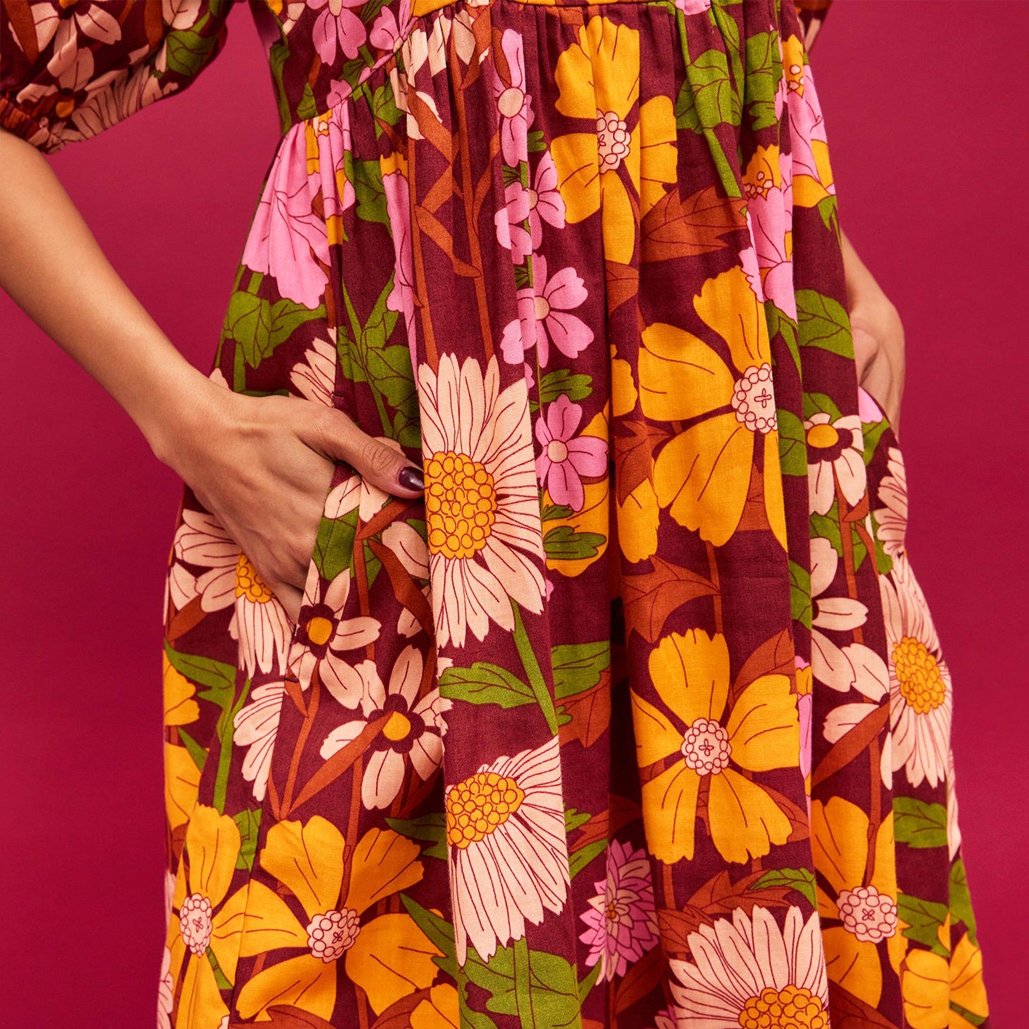 A mutli colored floral print maxi dress with puff sleeves and pockets.