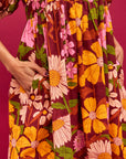 A mutli colored floral print maxi dress with puff sleeves and pockets.