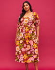 A mutli colored floral print maxi dress with puff sleeves and pockets. A mutli colored floral print maxi dress with puff sleeves and pockets.
