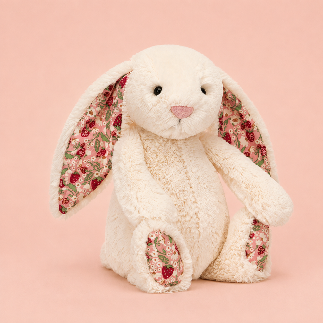 a cream colored plush bunny toy with strawberry pink ears and feet. 