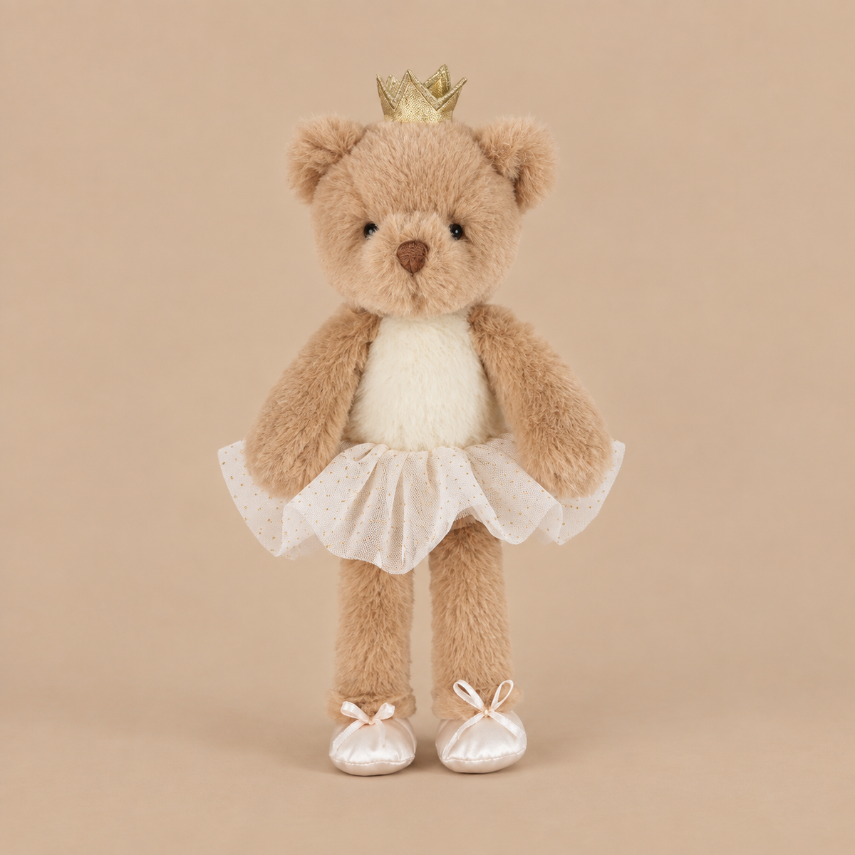 A bear shaped stuffed toy wearing a ballerina outfit and a crown
