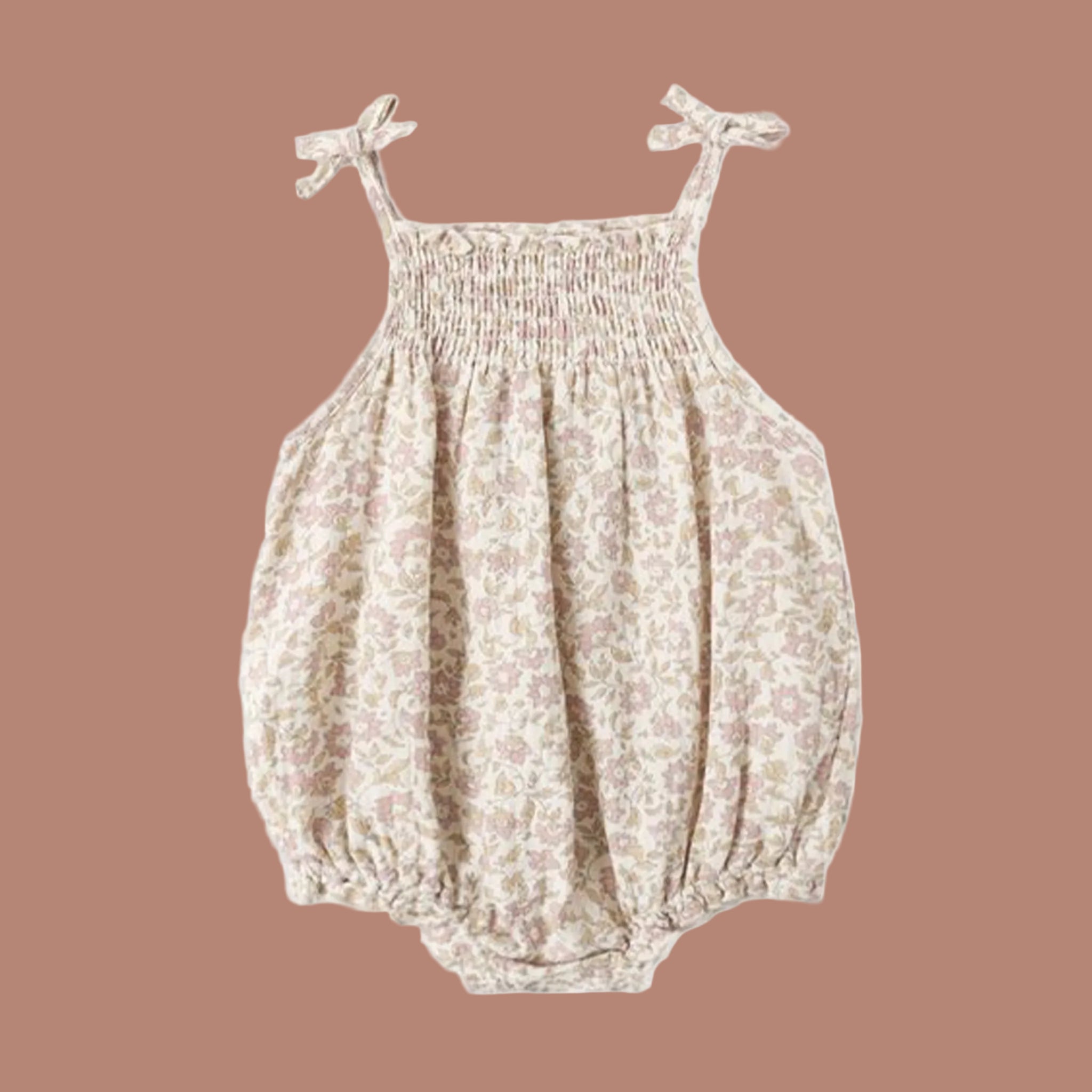 A bubble romper in a cream shade with a tulip print. 