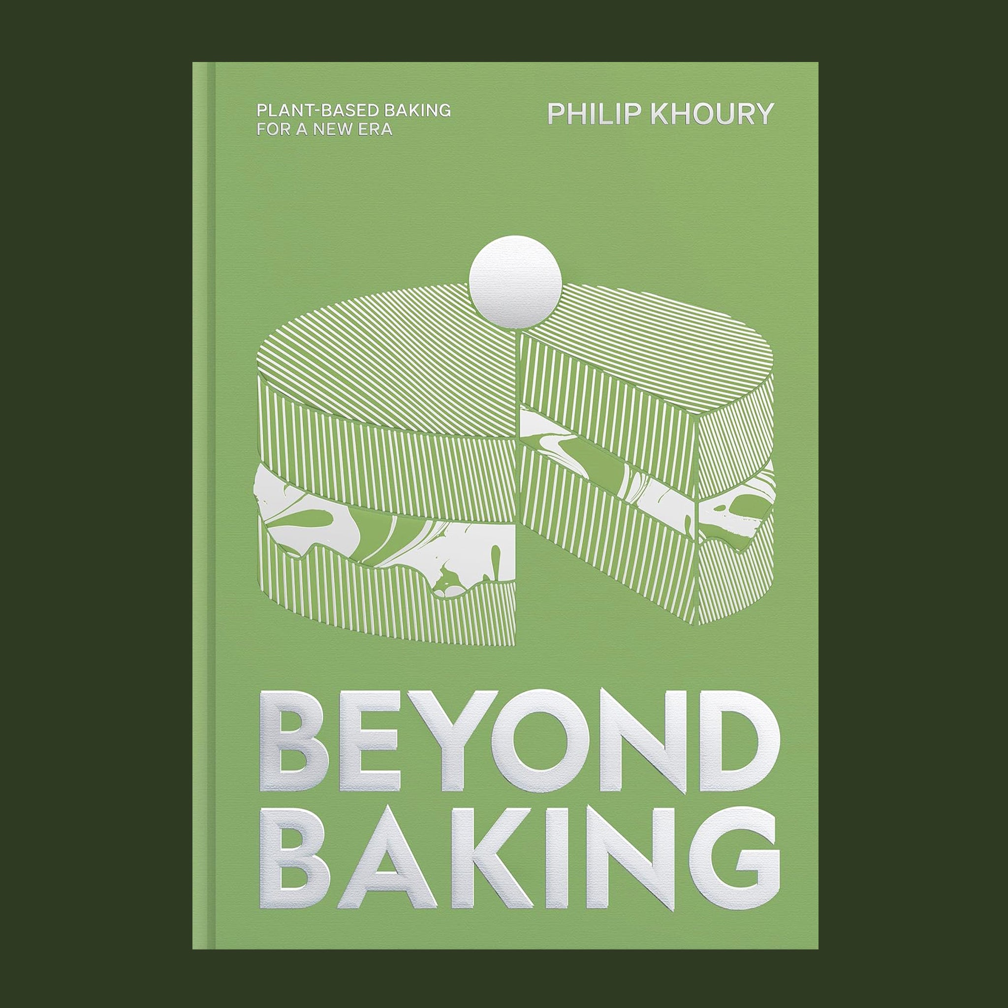 A light green bookcover with white and silver details of a cake illustration and text that reads, "Beyond Baking". 