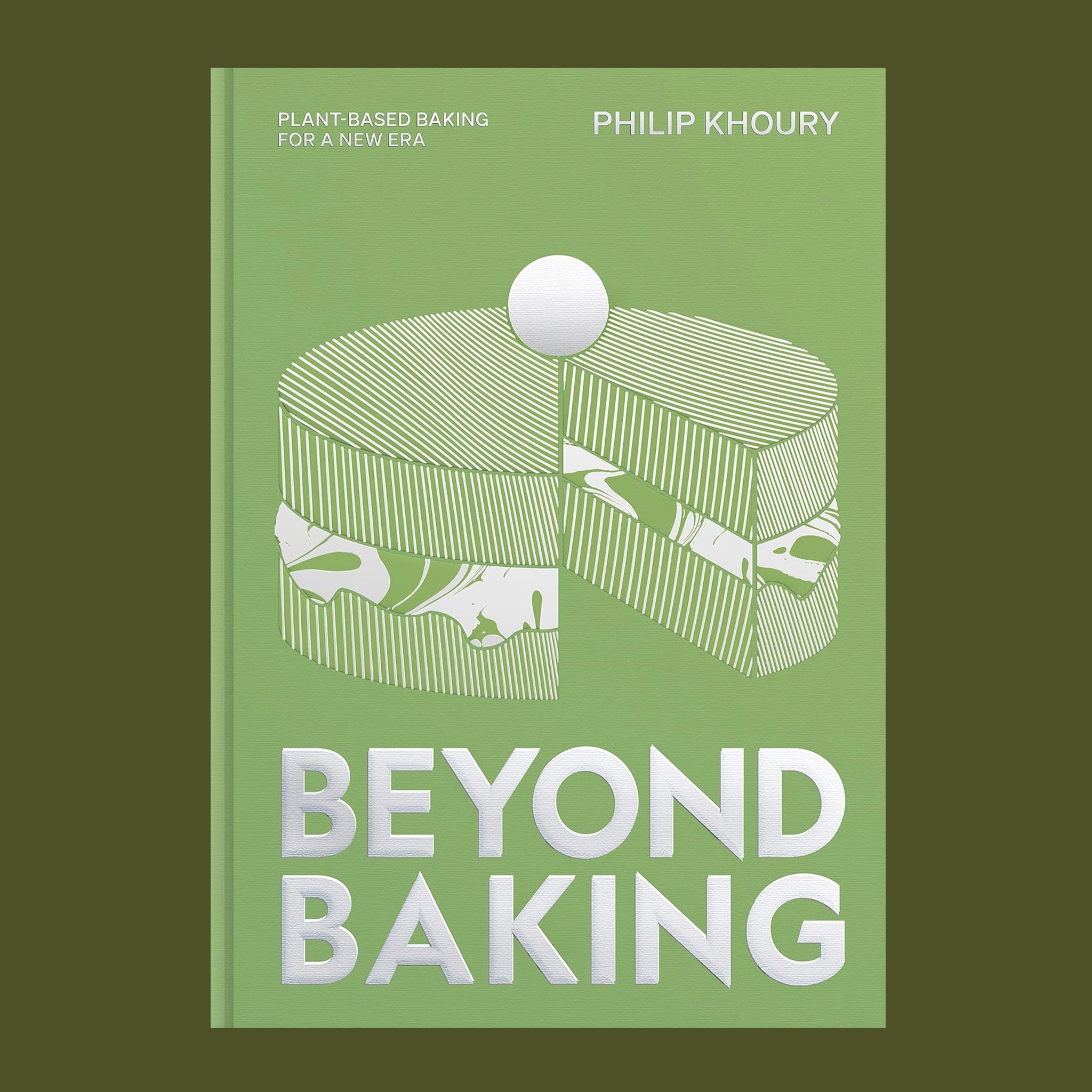 A light green bookcover with white and silver details of a cake illustration and text that reads, "Beyond Baking". 