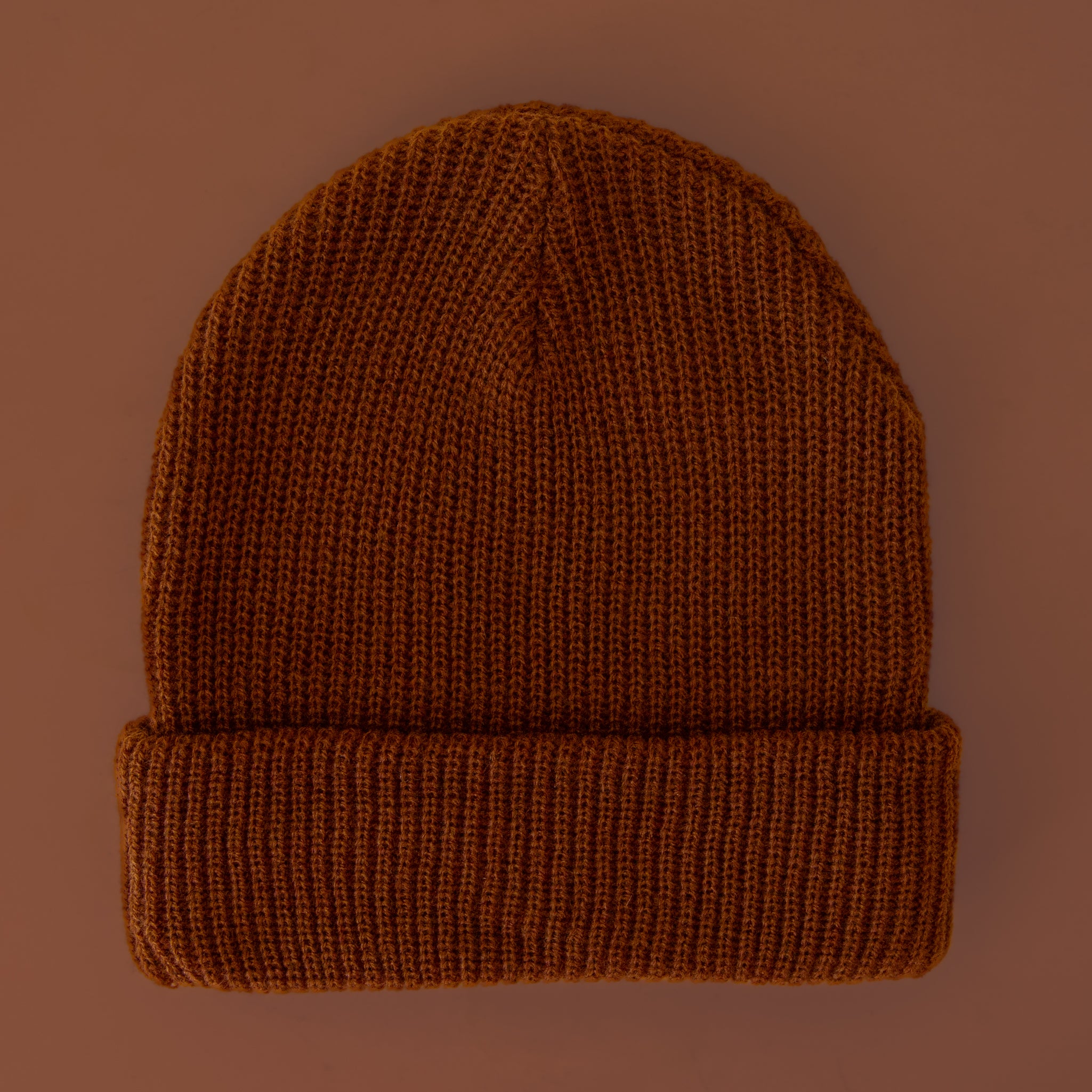 A chocolate colored ribbed beanie. 