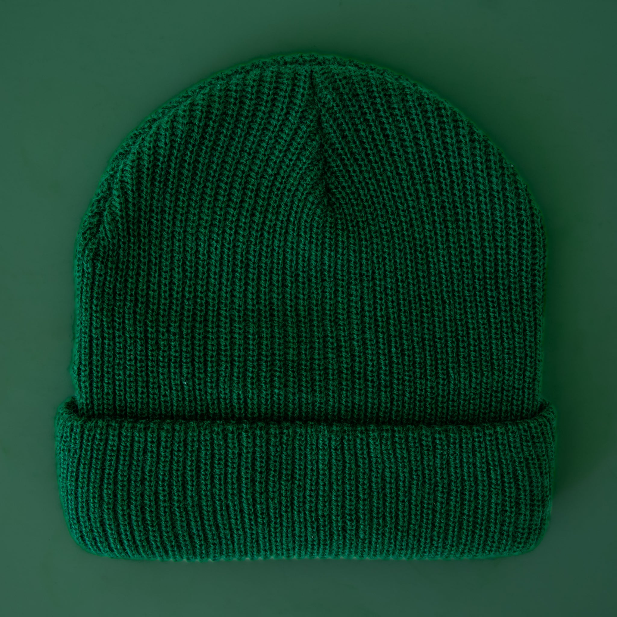 A green ribbed beanie. 