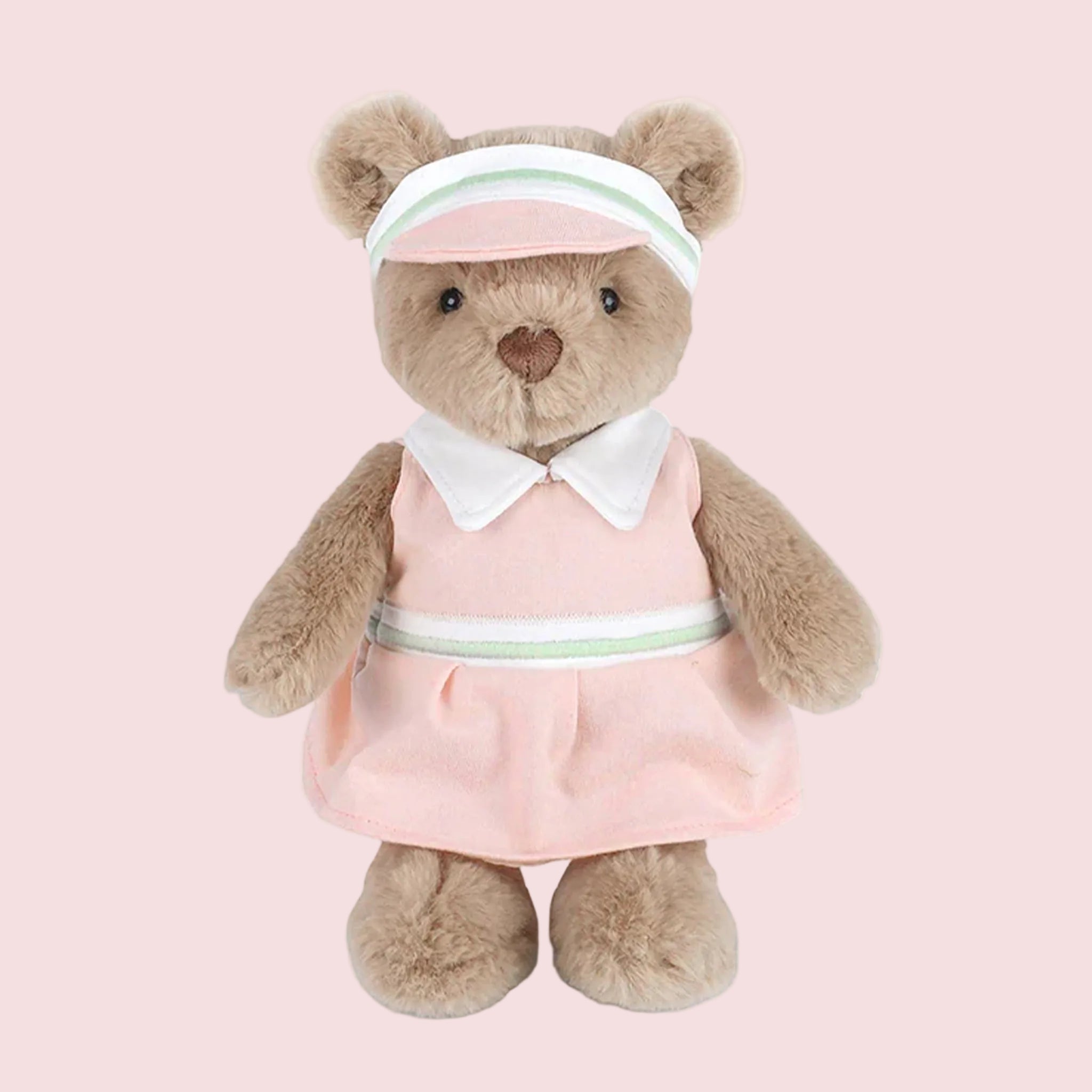 A bear stuffed animal wearing pink and mint gold attire. 