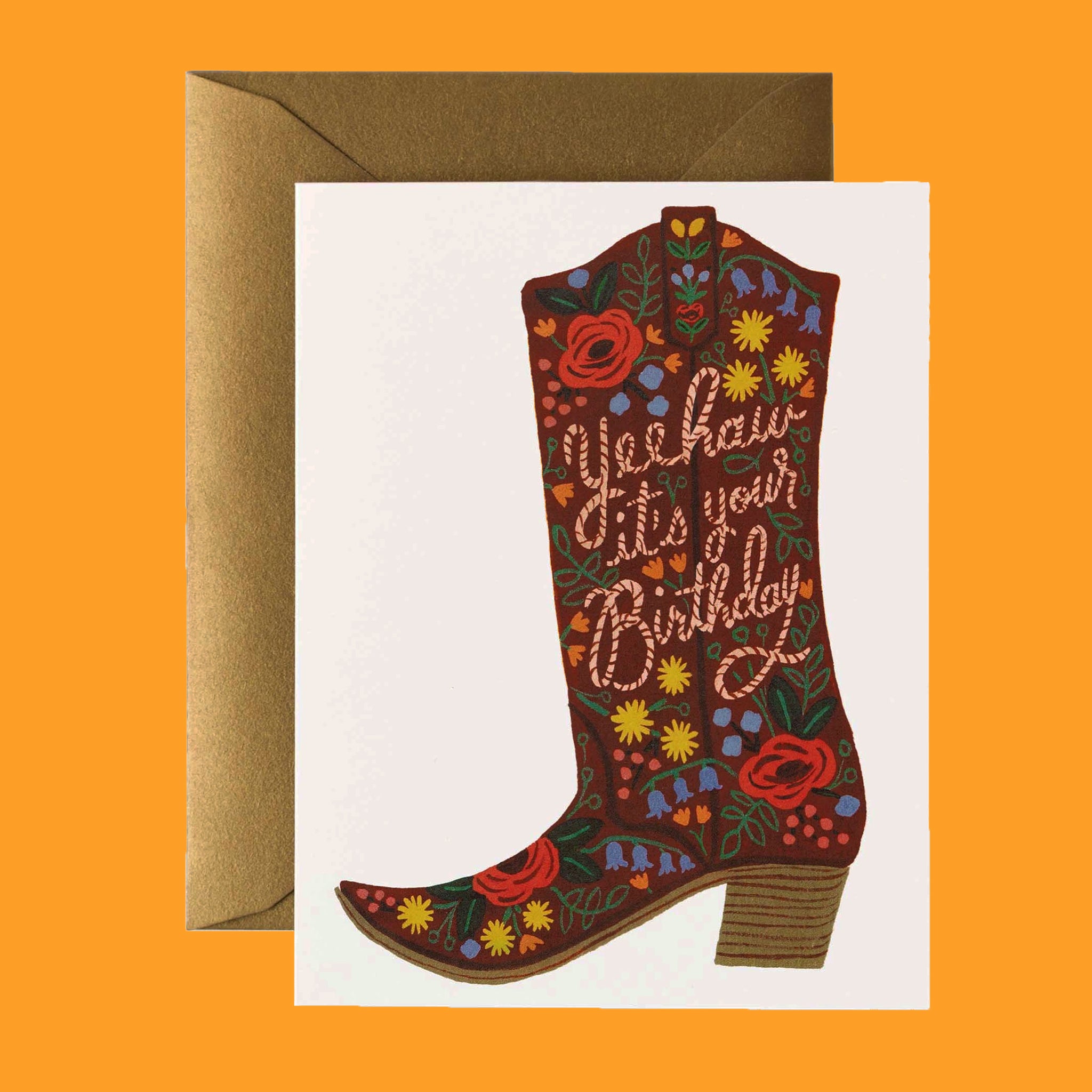 On an orange background is a card with a cowgirl boot with  a floral print and rope style text that reads, "Yeehaw it's your Birthday". 