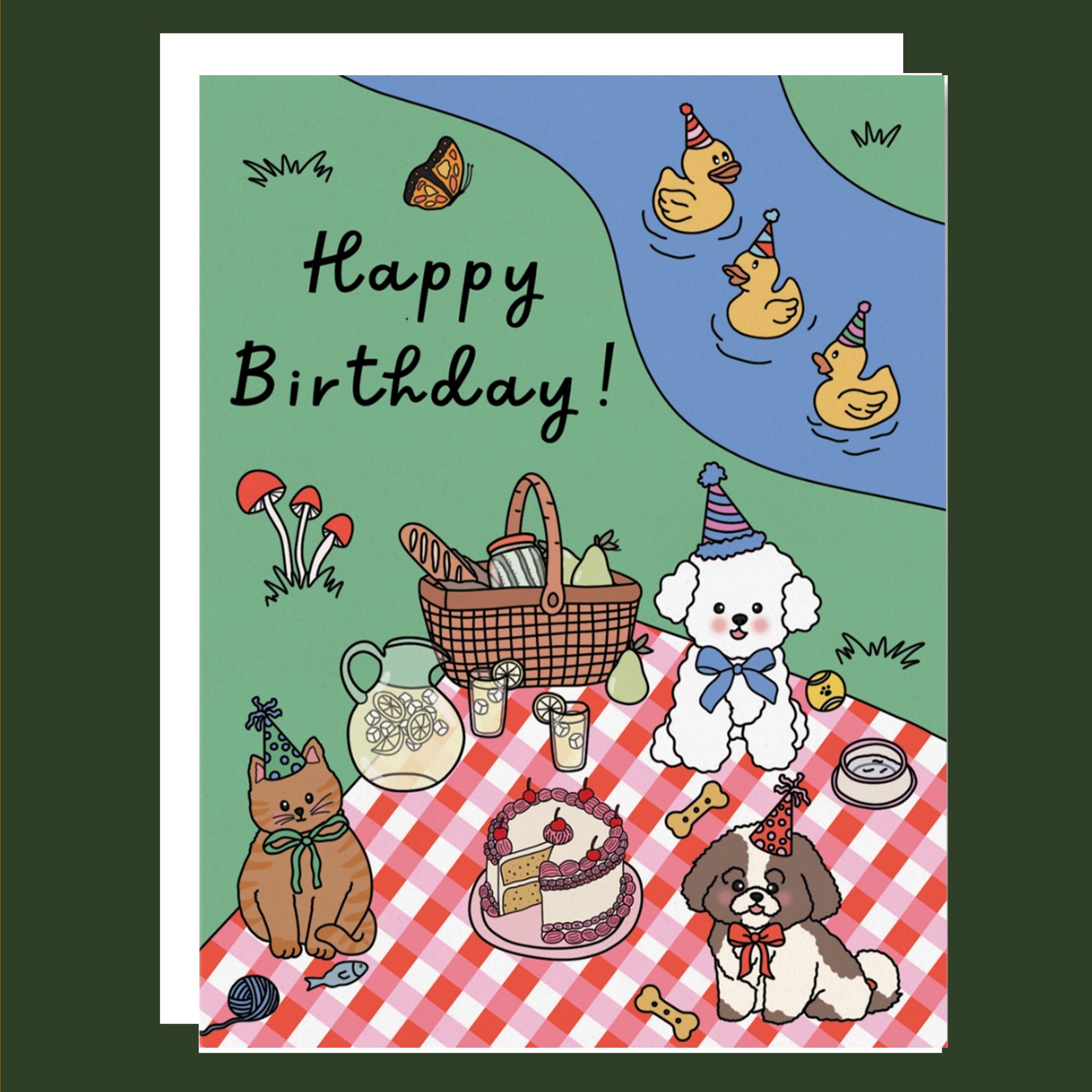 Birthday card with cartoon animals at a picnic and 'Happy Birthday!' text.