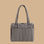 A black and cream gingham print nylon carry on bag.
