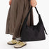 A black nylon shoulder bag.