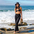 A model wearing a pair of black cotton wide leg pants with an elastic waistband. 