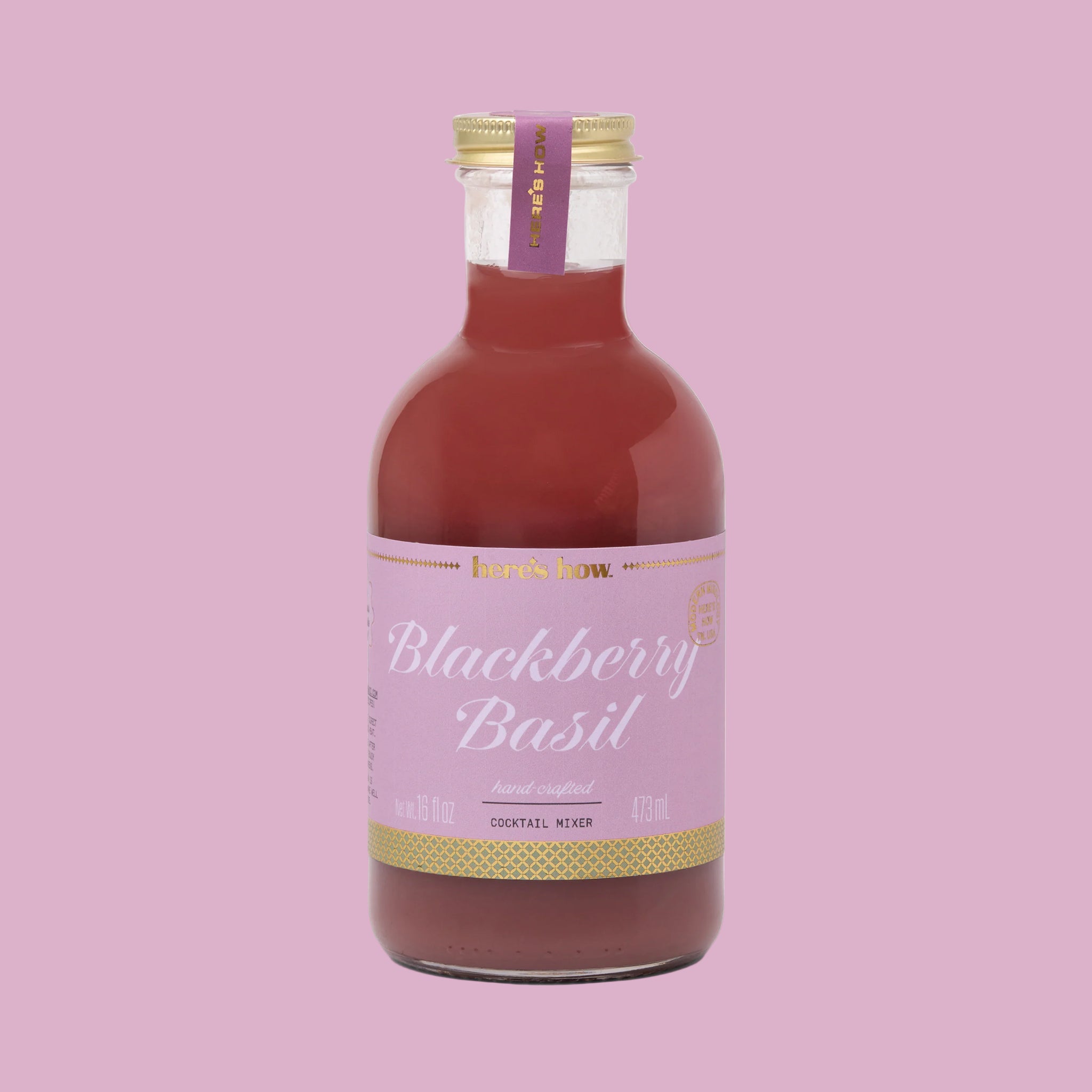 A bottle of cocktail mix with a light purple label that reads, 'Blackberry Basil'. 