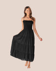A black tiered maxi dress with spaghetti straps. 